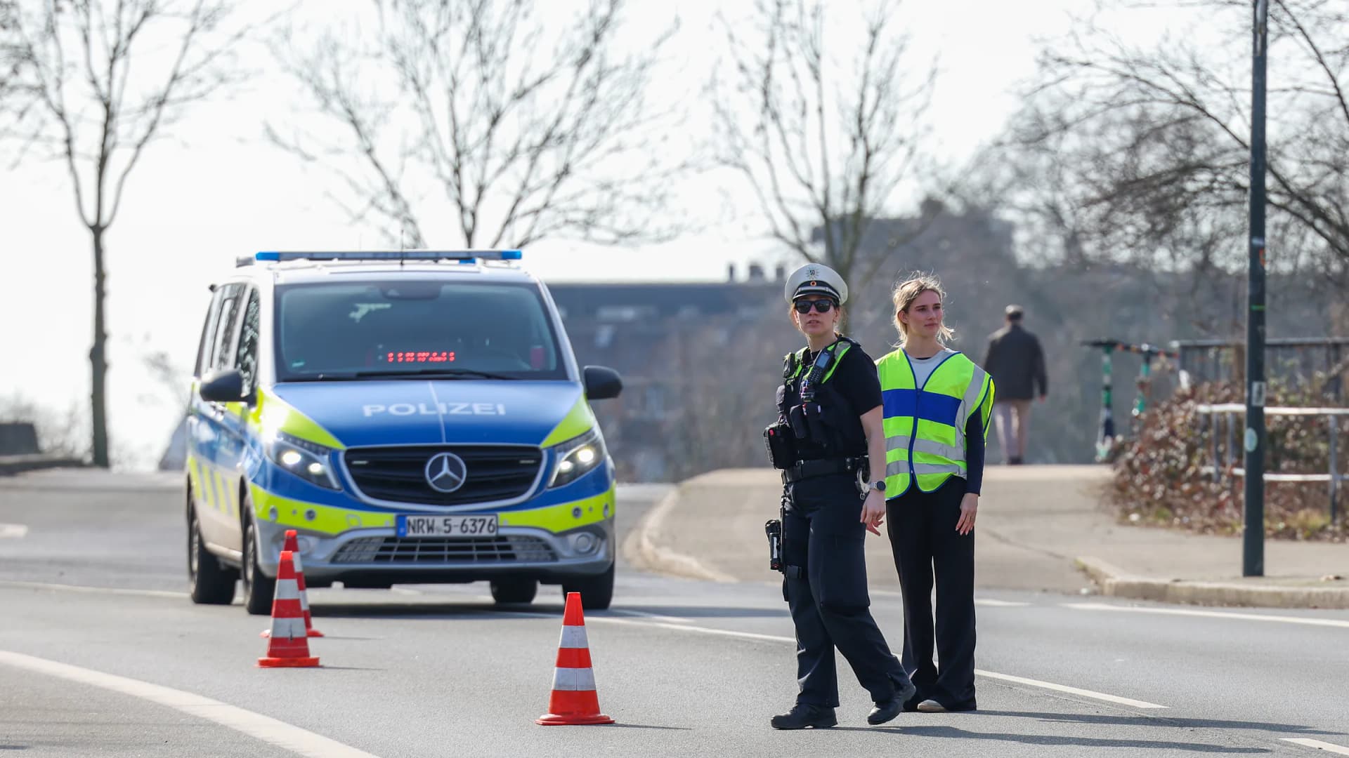 Police officers stand with their car on the side of the road at a traffic stop in Duesseldorf, North Rhine-Westphalia, Germany, on Thursday, Feb. 26, 2026. | Christoph Reichwein/dpa/picture-alliance/Newscom