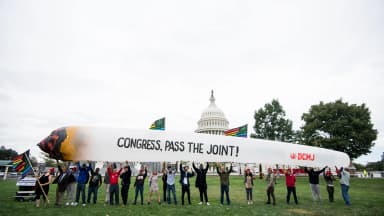 Marijuana activists hold up a 51-foot inflatable joint during a rally at the U.S. Capitol to call on Congress to pass cannabis reform legislation on Tuesday, Oct. 8, 2019. | Bill Clark/CQ Roll Call/Newscom