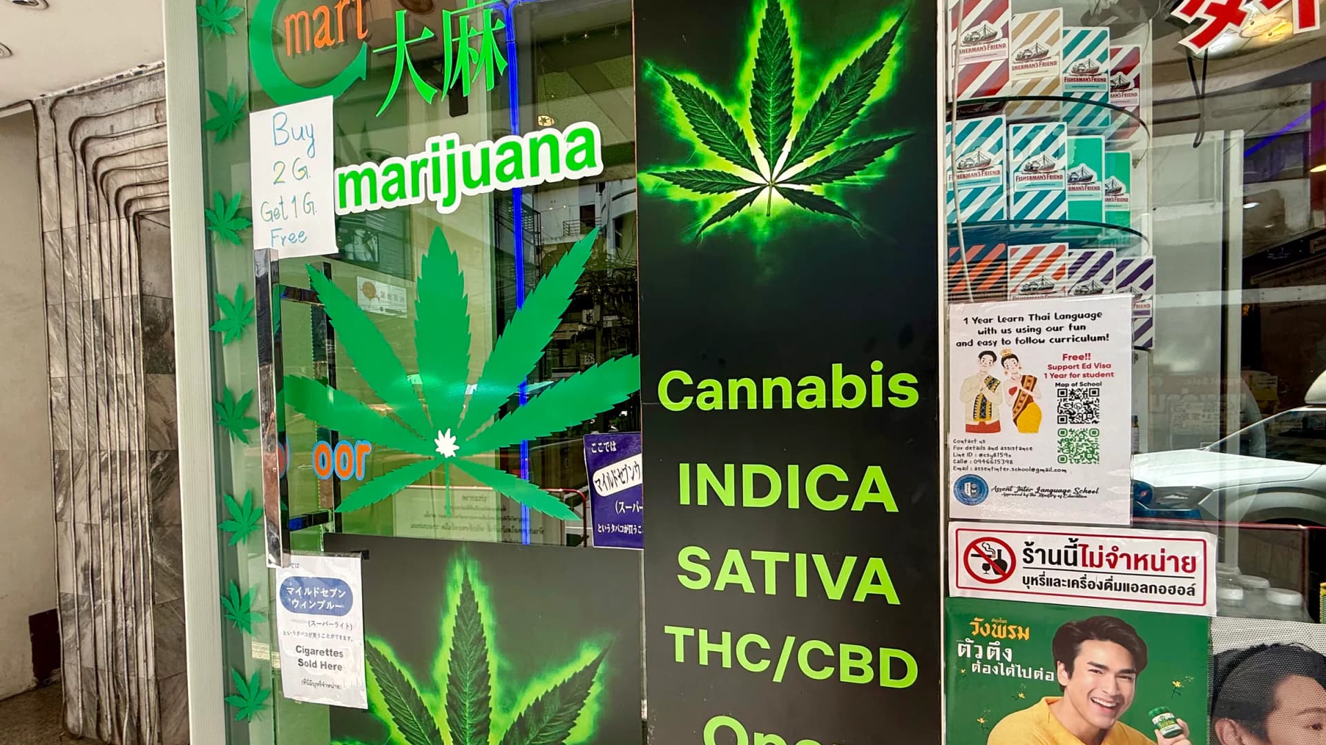 A cannabis shop in Bangkok displays Marijuana Ganja Weed Cannabis with cannabis leaf graphics on its red signage. (Newscom)