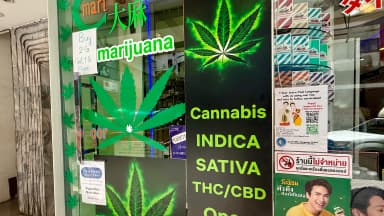 A cannabis shop in Bangkok displays Marijuana Ganja Weed Cannabis with cannabis leaf graphics on its red signage. (Newscom)