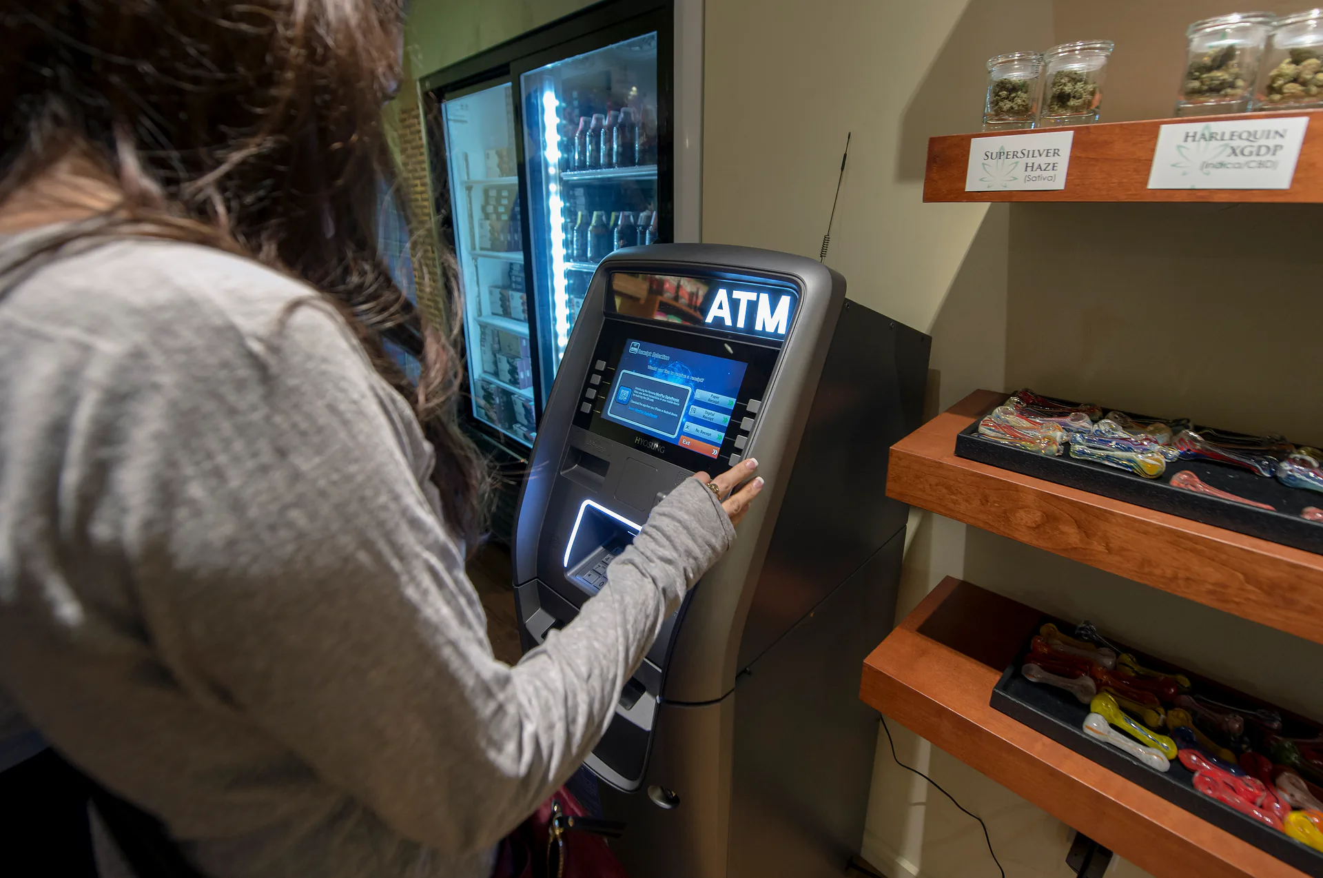 Jennifer Pompa withdraws cash from an ATM inside Torrey Holistics in San Diego, California, Monday, Jan. 1, 2018.