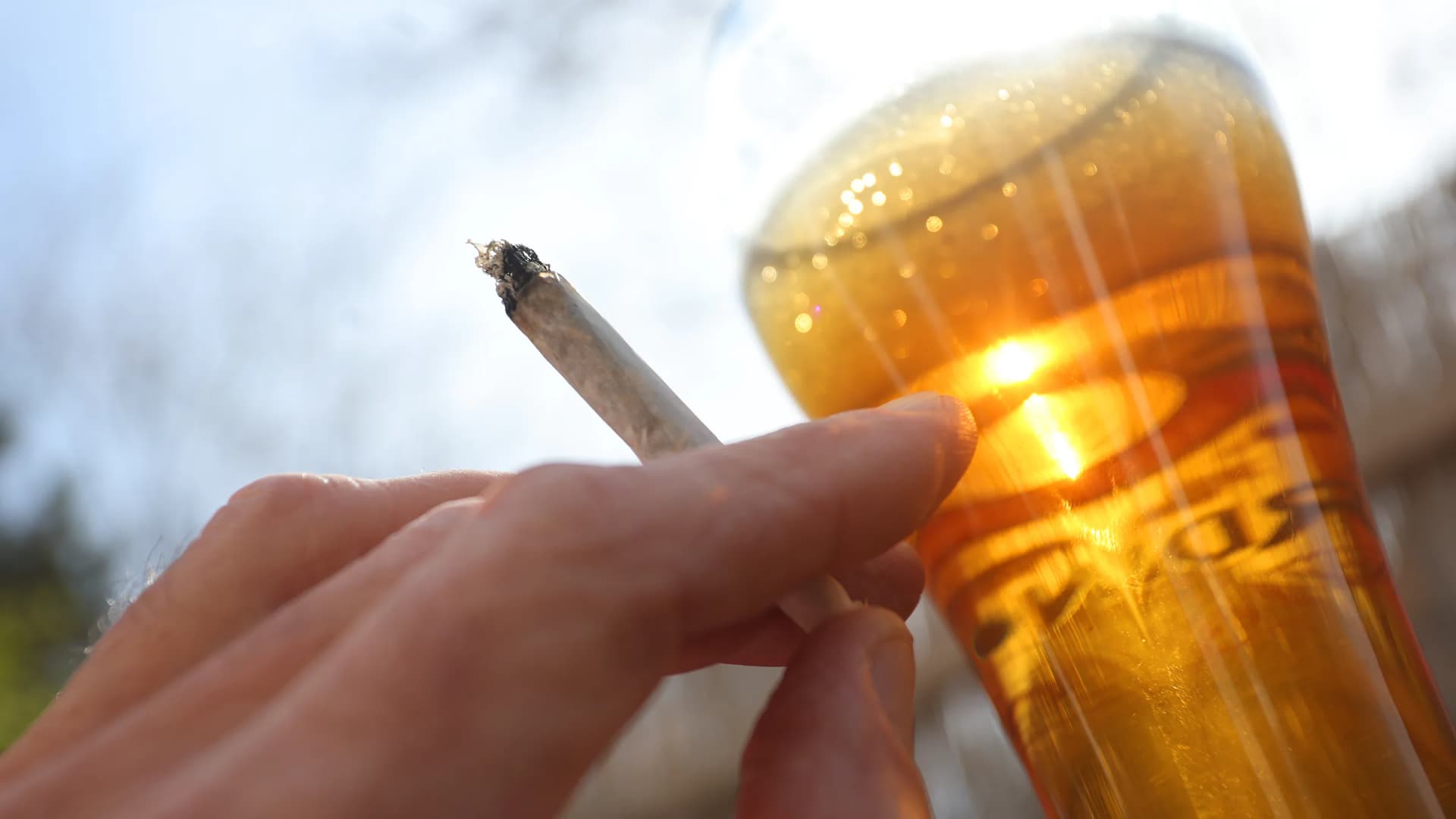 A hand holds a joint next to a glass of beer in Kaufbeuren, Bavaria, Wednesday, March 20, 2024. | Karl-Josef Hildenbrand/dpa/Newscom