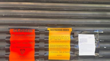 A Notice of Order of Closure sign is posted on the gate of an unlicensed cannabis smoke shop in New York. | Deb Cohn-Orbach/UCG/Universal Images Group/Newscom