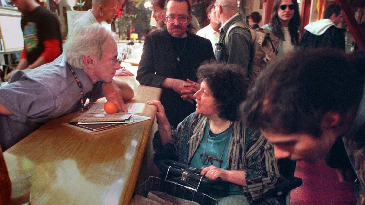 Dennis Peron leans in to listen to Sue Glover, who has multiple sclerosis, at the Cannabis Buyers' Club bar in San Francisco in 1996. The club provided marijuana for medical purposes. | Karl Mondon/KRT/Newscom