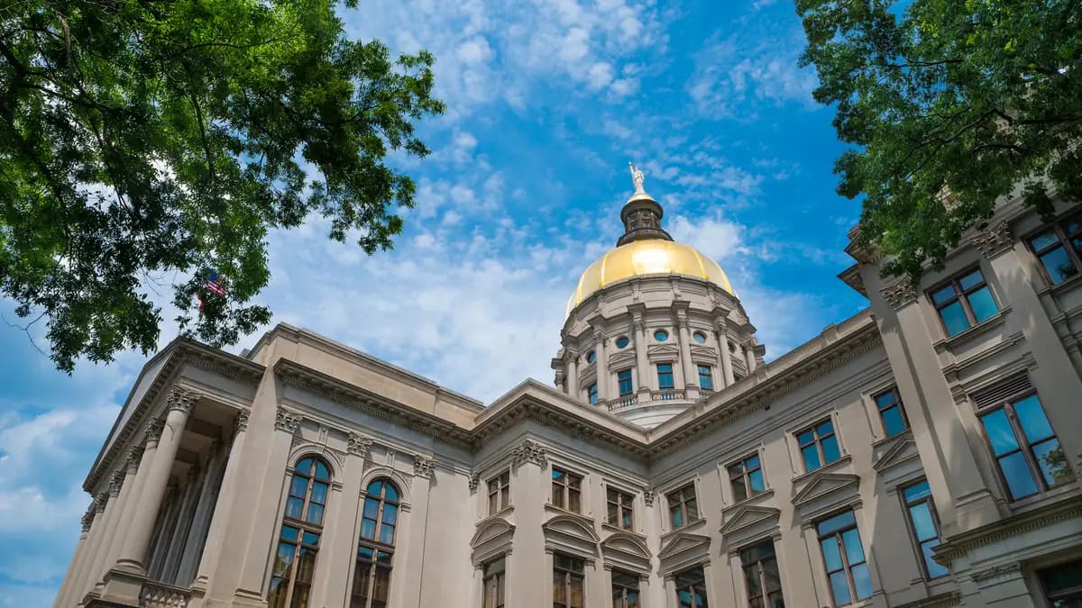 The gold dome of the Georgia State Capitol rises above the building's columned facade in Atlanta. | DPST/Newscom