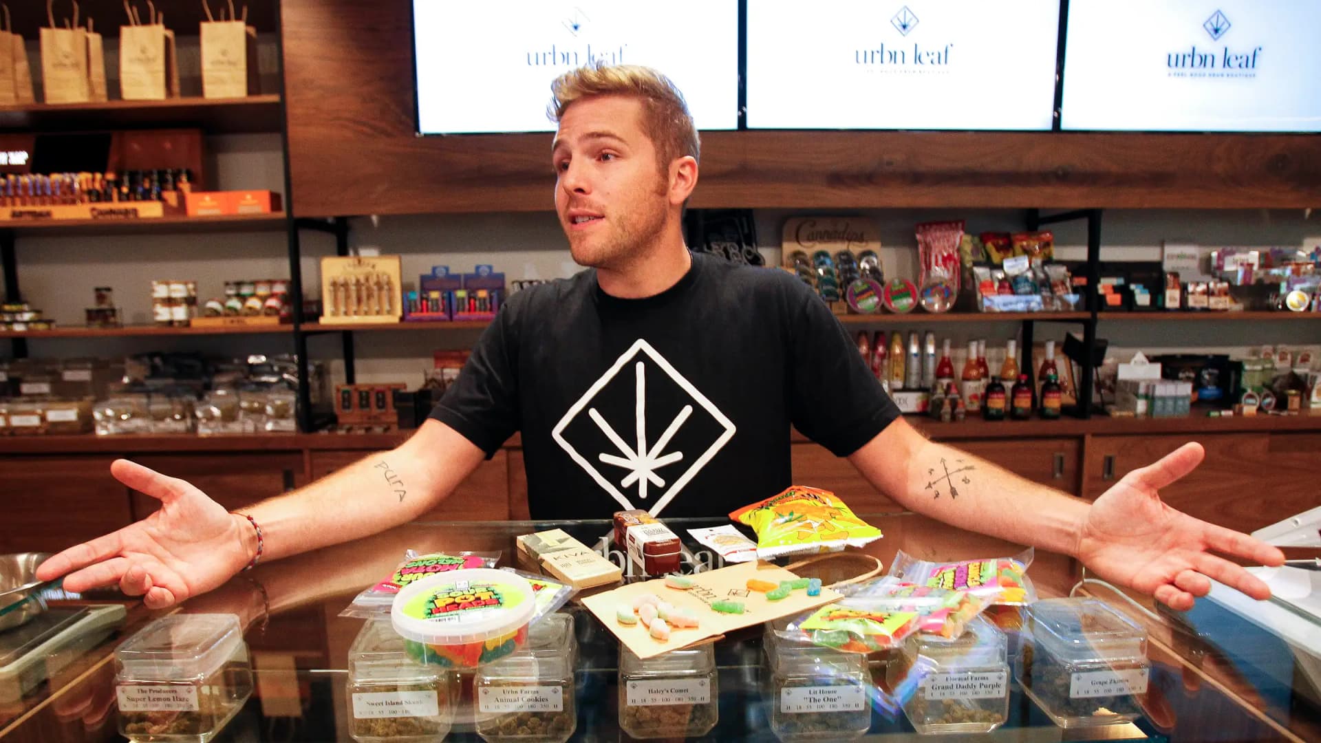 Budtender Jay Frentsos shows marijuana edibles at the Urbn Leaf dispensary in San Diego on Nov. 14, 2017. First-time customers at shops like this one often face a regulated, ID-checked buying process. (Hayne Palmour IV/San Diego Union-Tribune/TNS/Newscom)