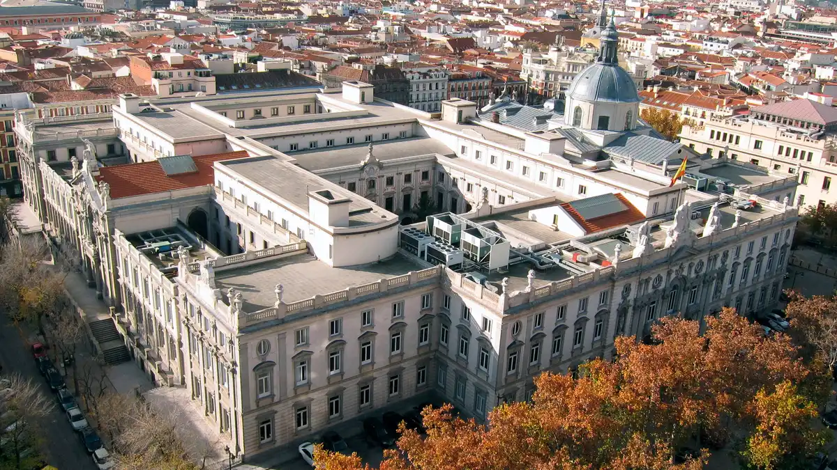 Aerial view of the Spanish Supreme Court, a large neoclassical stone building with a dome, surrounded by Madrid rooftops and autumn trees. | FDV/Wikimedia Commons (CC BY-SA 3.0)